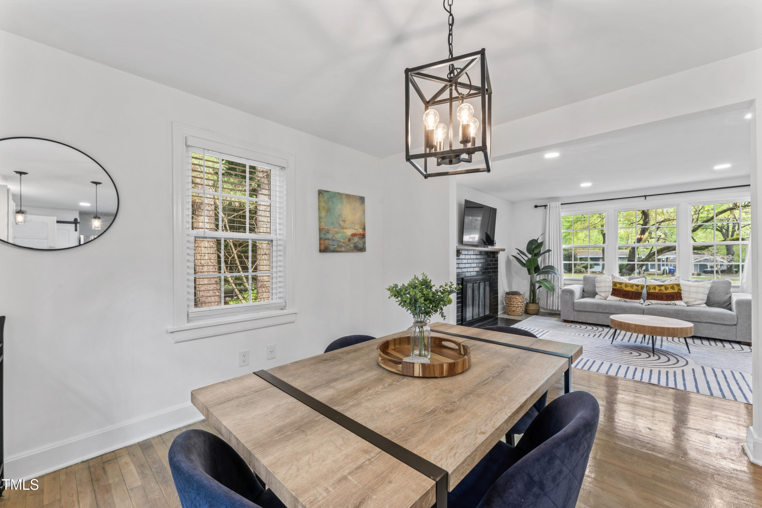 711 Horton Road Durham, NC 27704 - Photo 12 of 28 a view of a dining room with furniture a chandelier and wooden floor