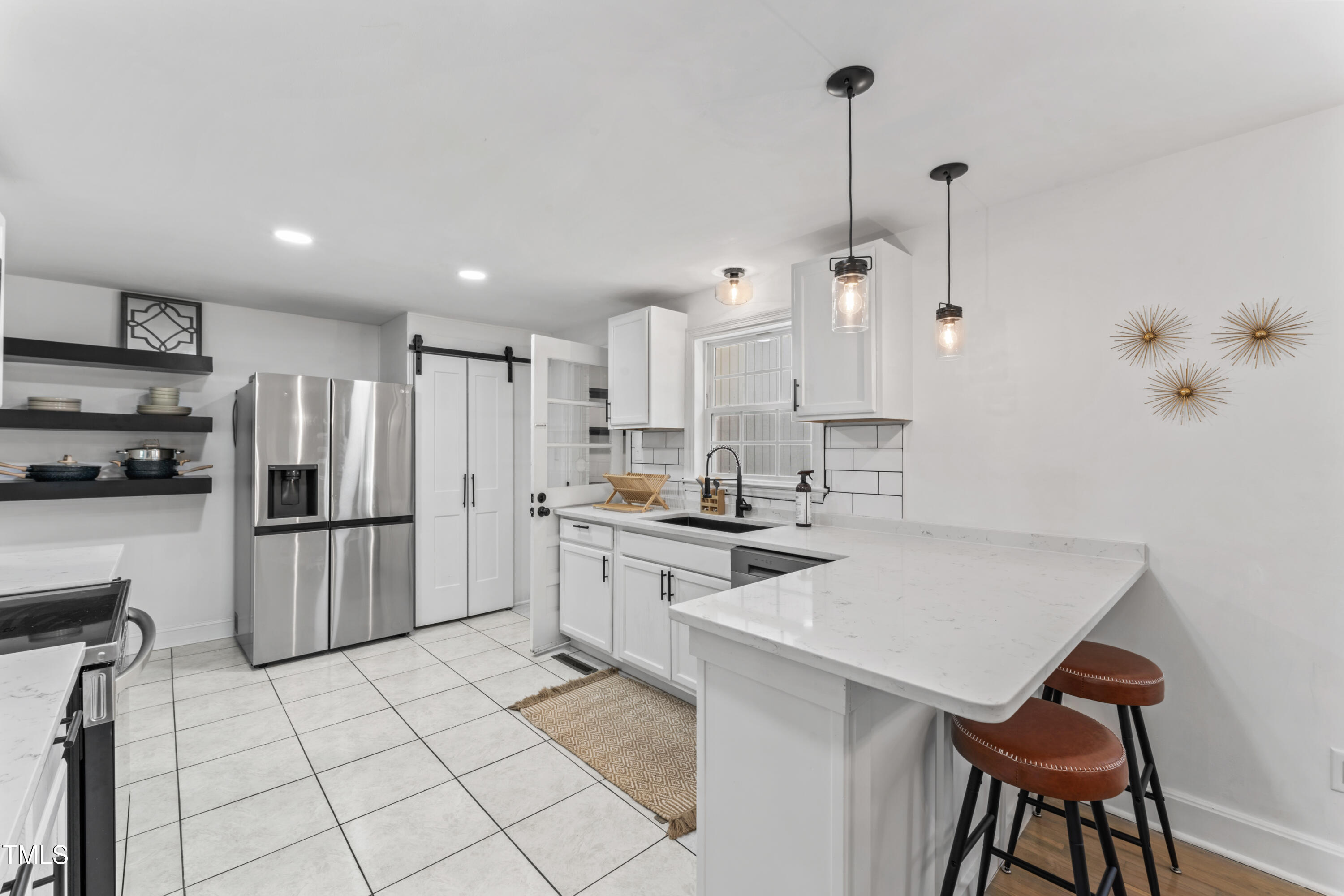 711 Horton Road Durham, NC 27704 - Photo 13 of 28 a kitchen with stainless steel appliances a refrigerator sink and microwave