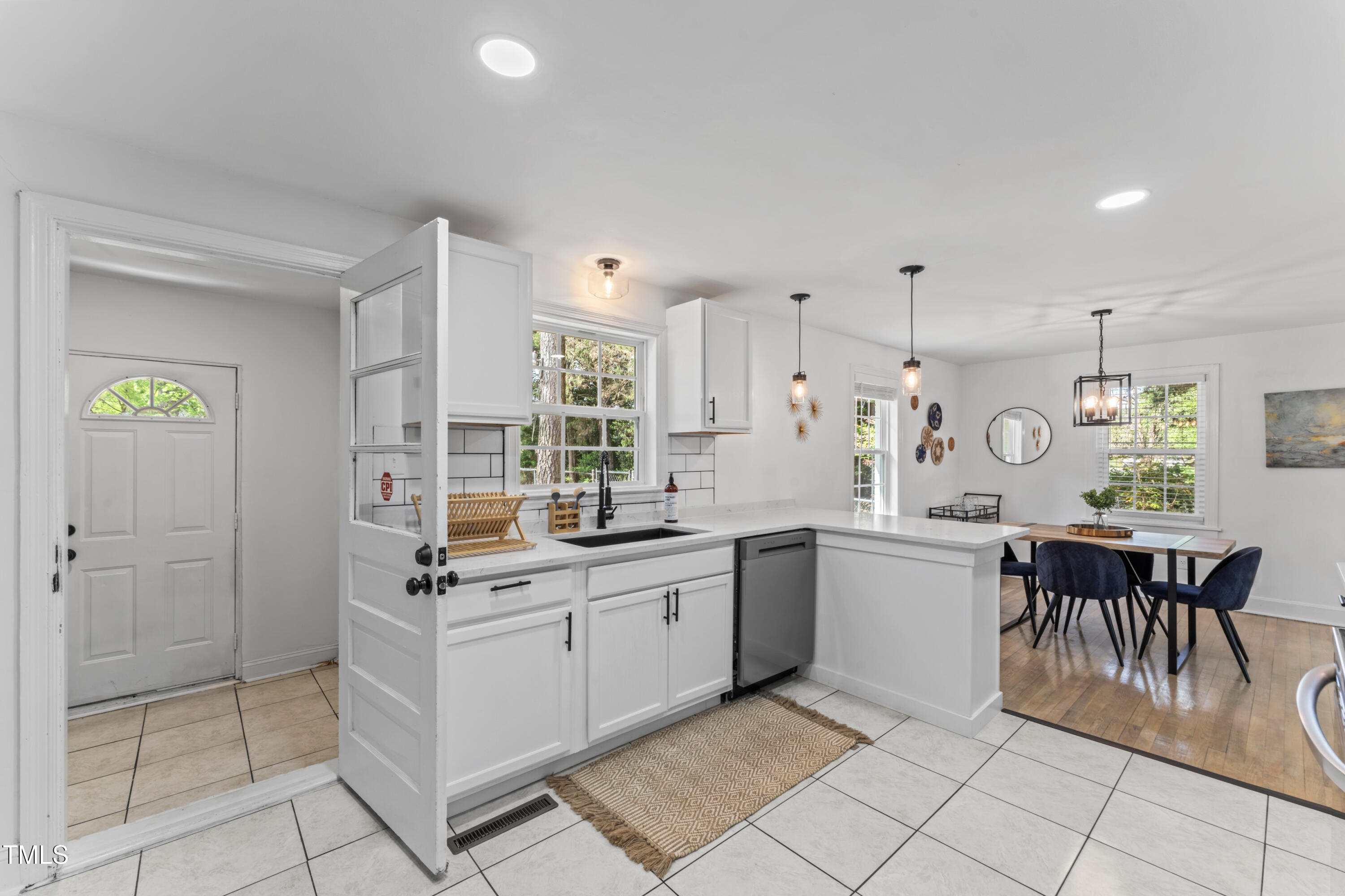 711 Horton Road Durham, NC 27704 - Photo 14 of 28 a kitchen with a sink and chairs