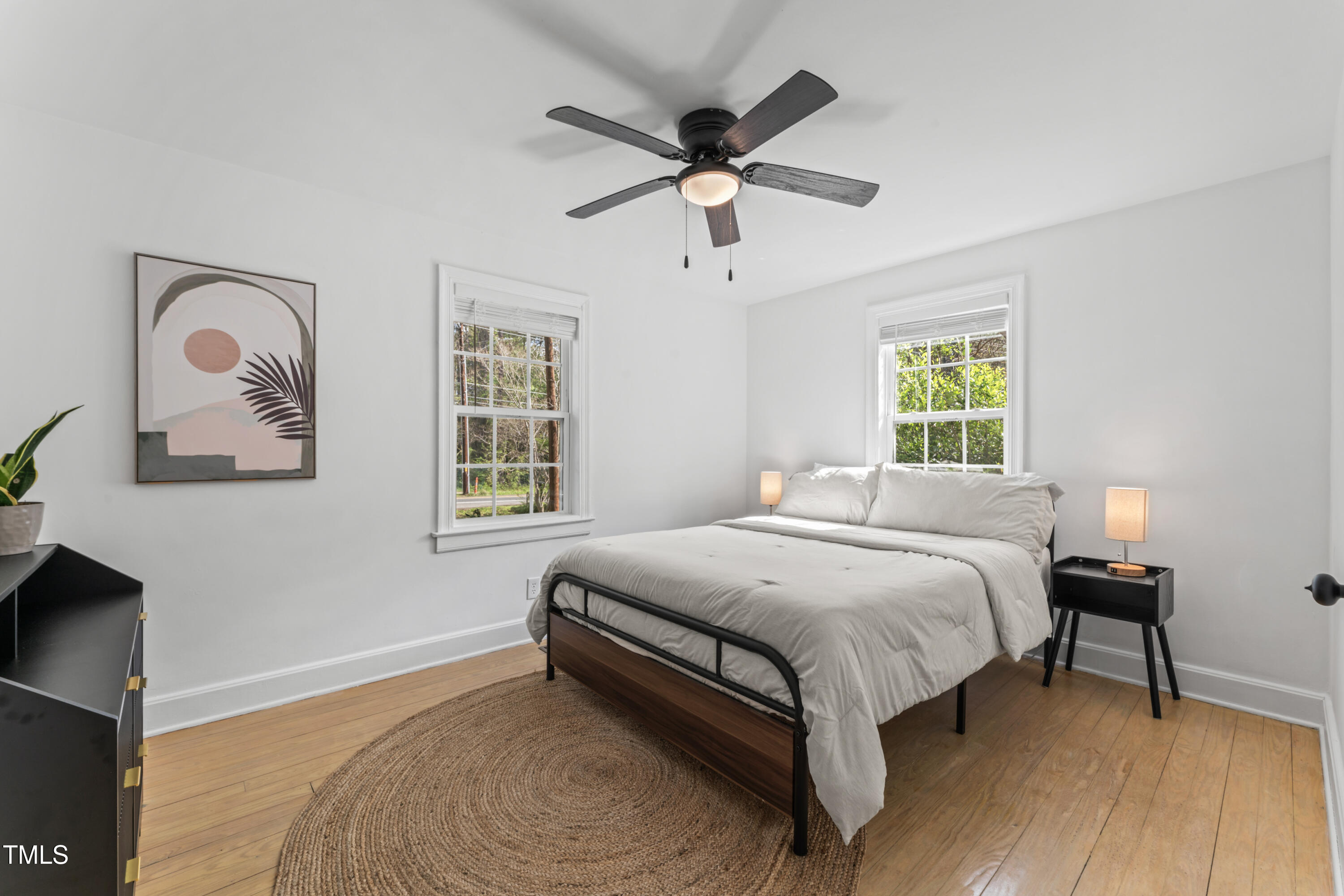 711 Horton Road Durham, NC 27704 - Photo 19 of 28 a bedroom with a bed and a chandelier