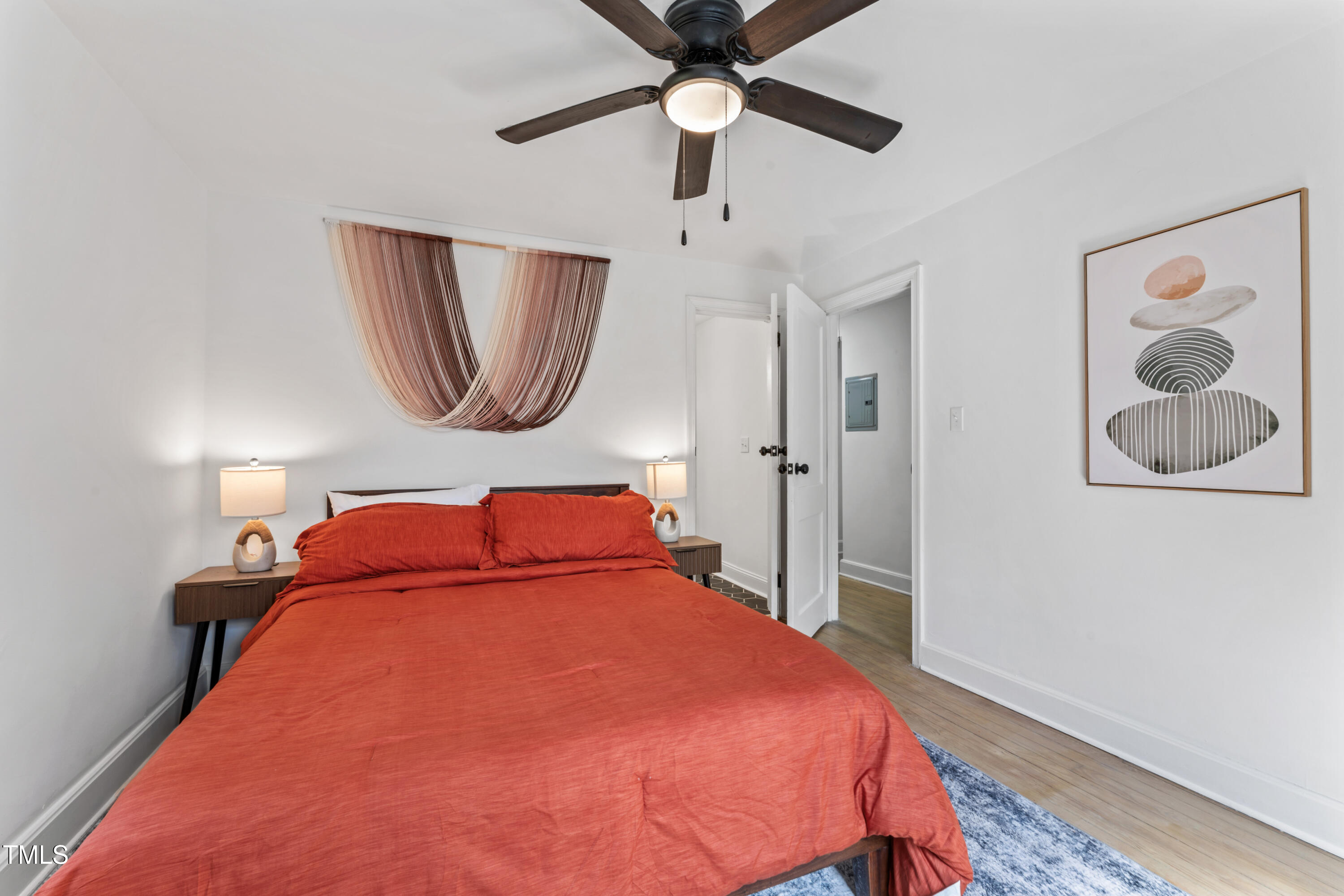 711 Horton Road Durham, NC 27704 - Photo 21 of 28 a bedroom with a bed and a chandelier