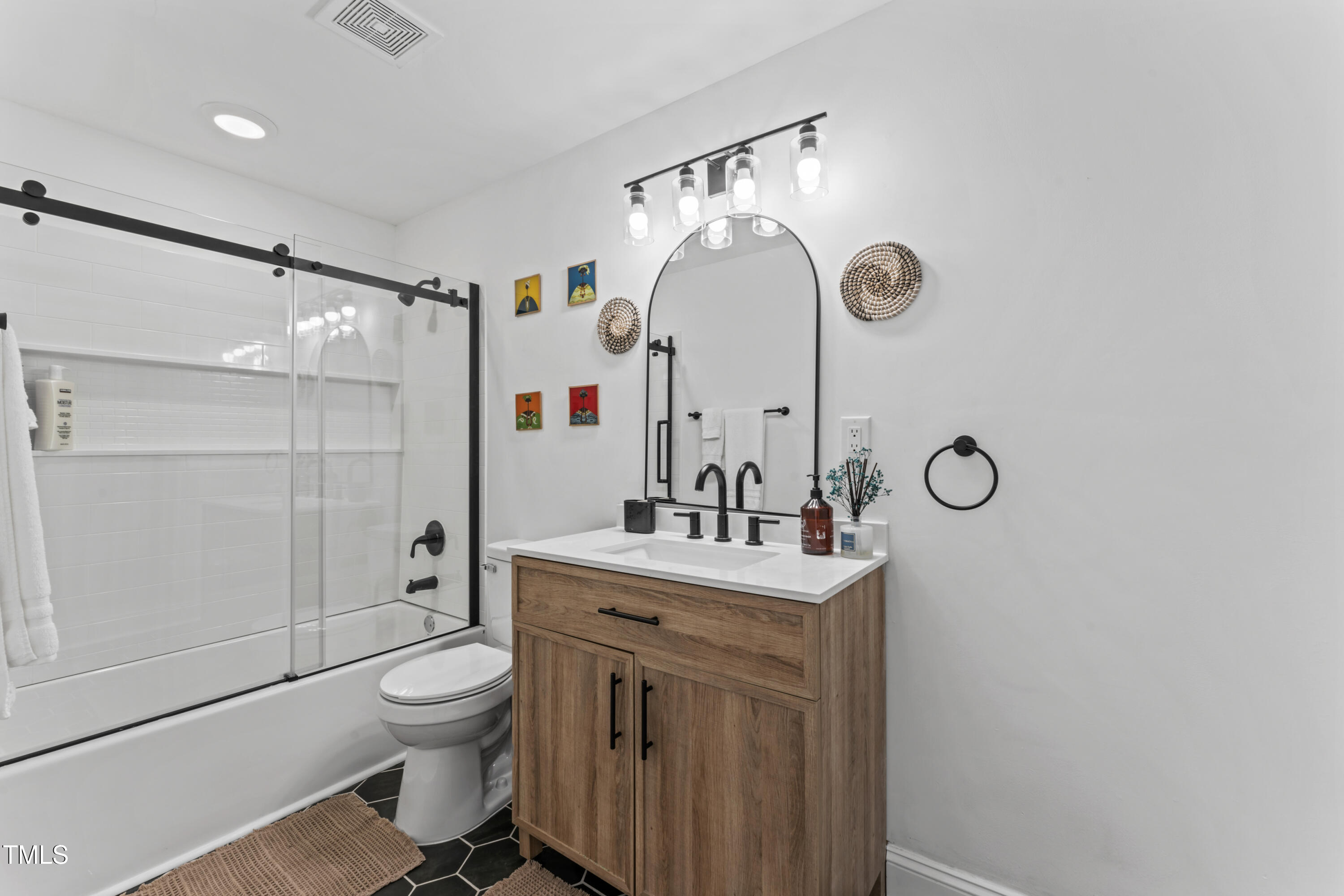 711 Horton Road Durham, NC 27704 - Photo 22 of 28 a bathroom with a sink a toilet and shower