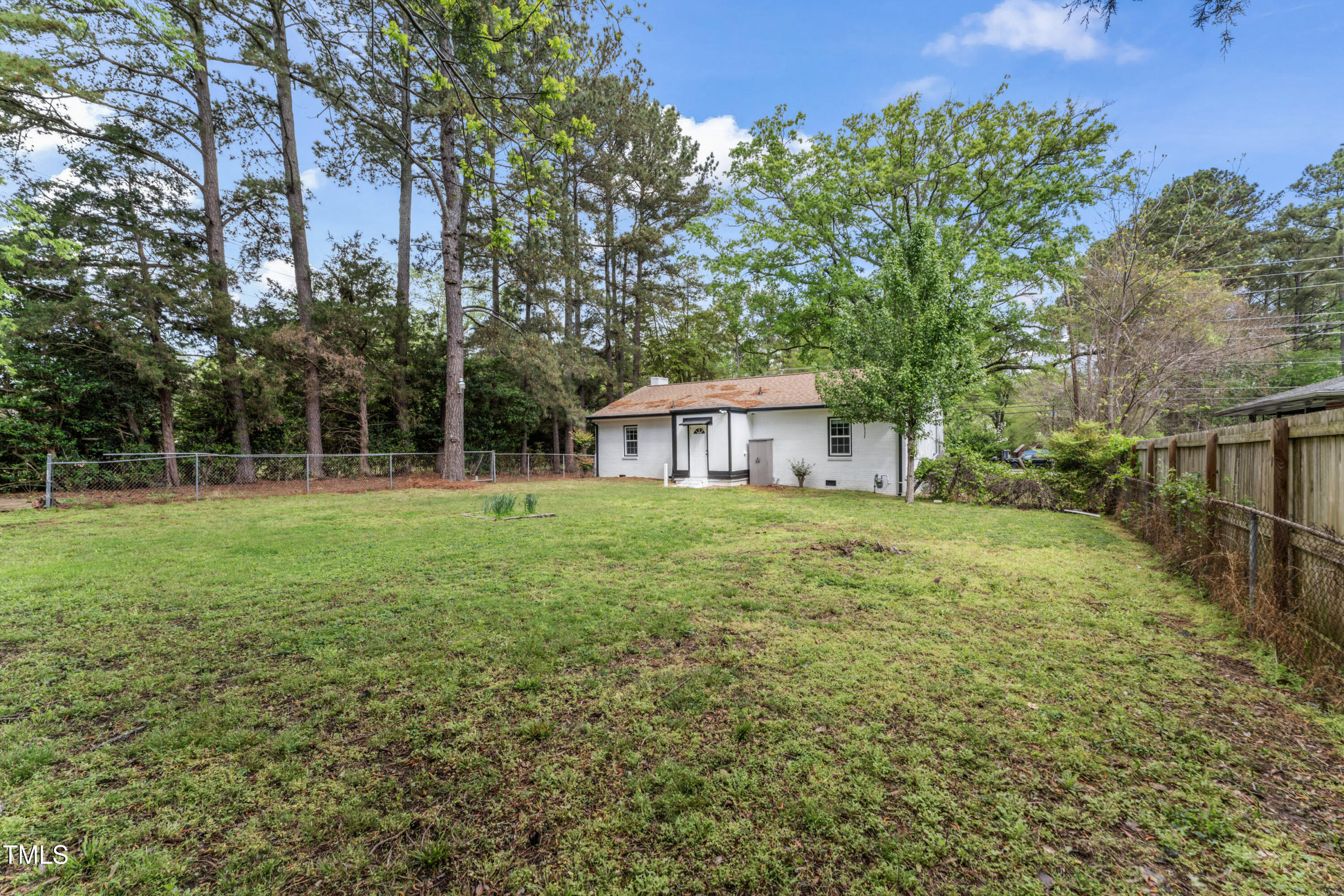 711 Horton Road Durham, NC 27704 - Photo 25 of 28 a view of a house with backyard and trees
