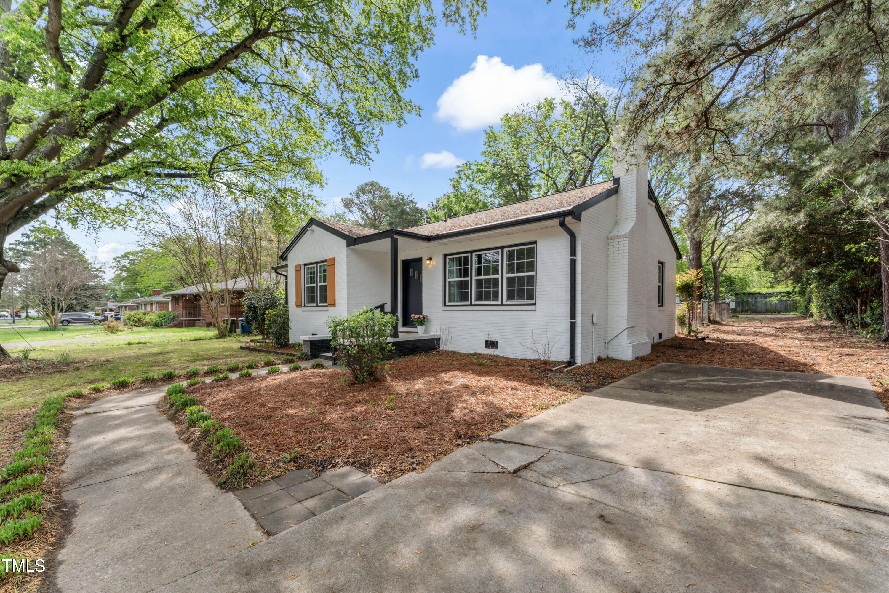 711 Horton Road Durham, NC 27704 - Photo 28 of 28 a view of a house with backyard and a tree