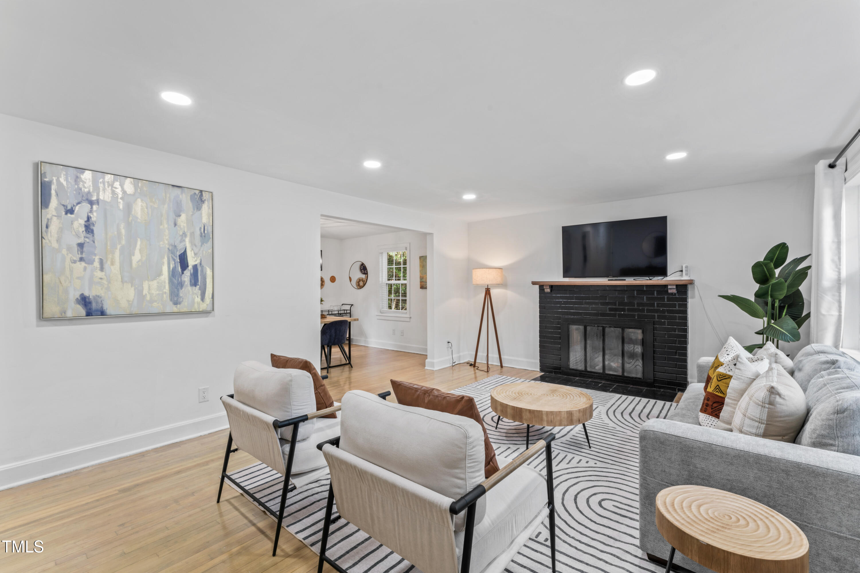 711 Horton Road Durham, NC 27704 - Photo 6 of 28 a living room with furniture a fireplace and a flat screen tv