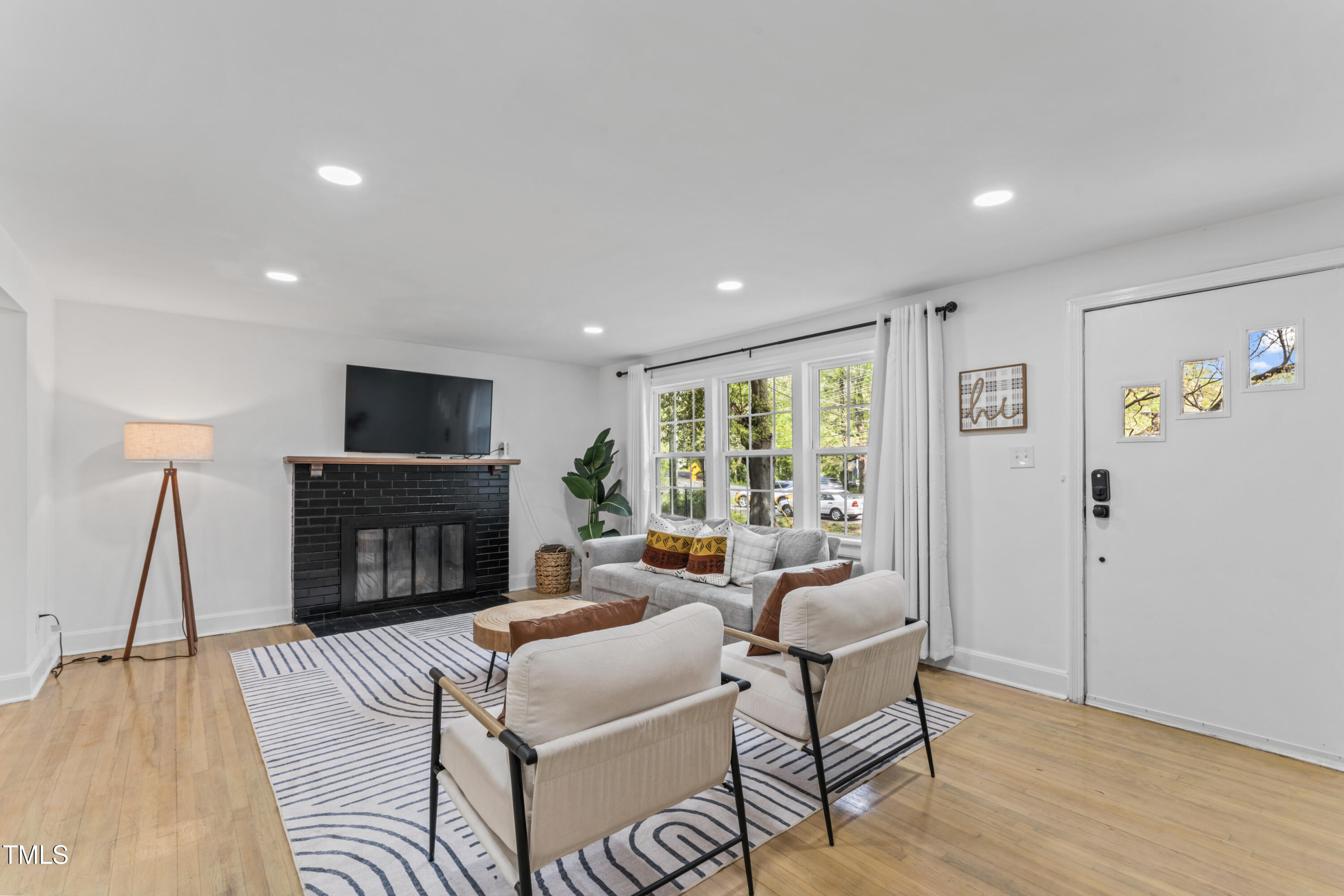 711 Horton Road Durham, NC 27704 - Photo 8 of 28 a living room with furniture and a fireplace