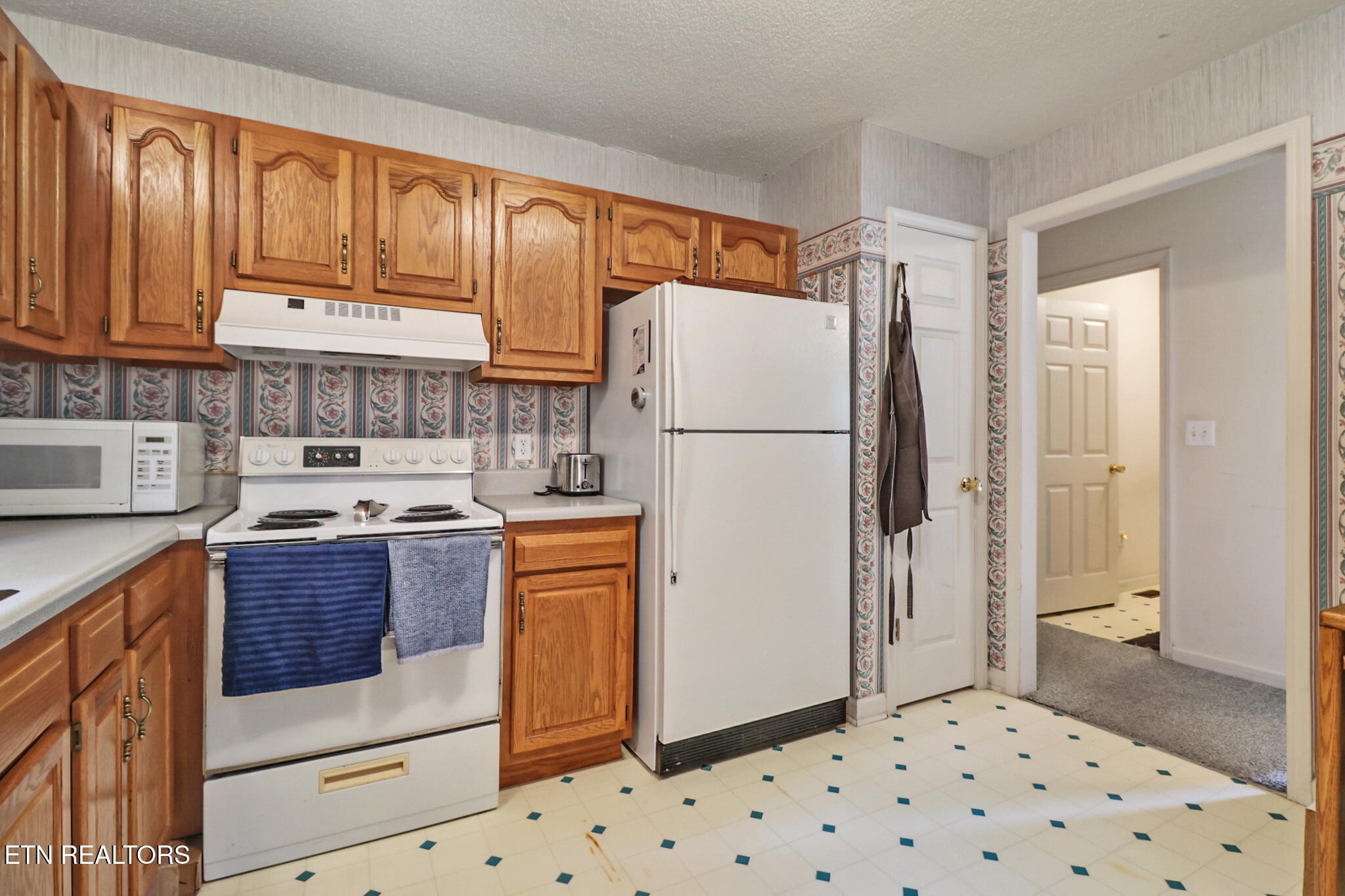 101 Ashdown Lane Crossville, TN 38558 - Photo 22 of 34 a kitchen with stainless steel appliances granite countertop a refrigerator sink and cabinets
