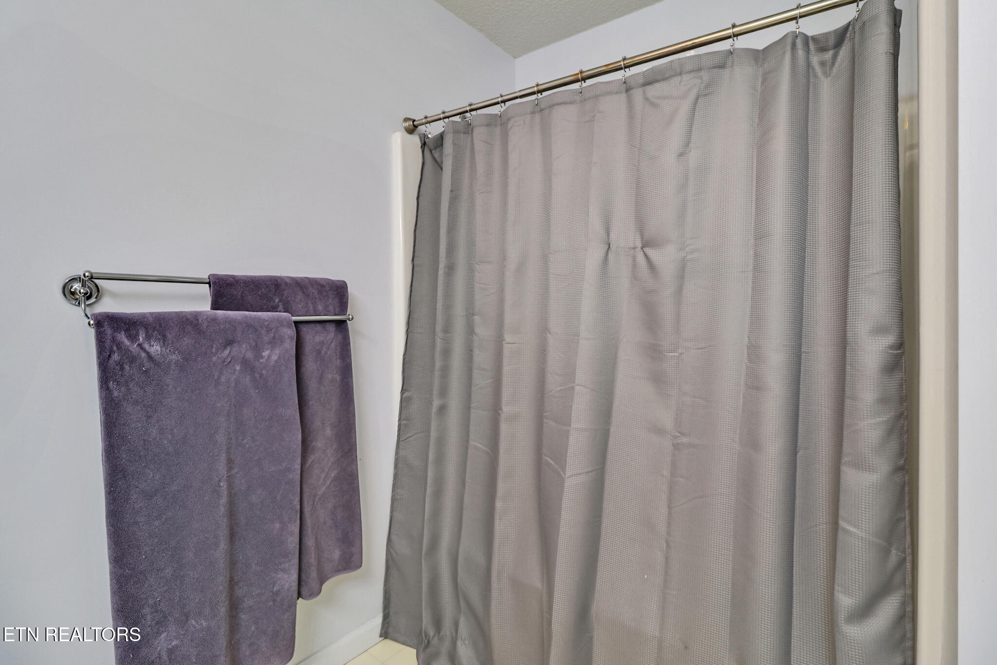 101 Ashdown Lane Crossville, TN 38558 - Photo 27 of 34 a view of a bathroom with shower curtain and a shower curtain