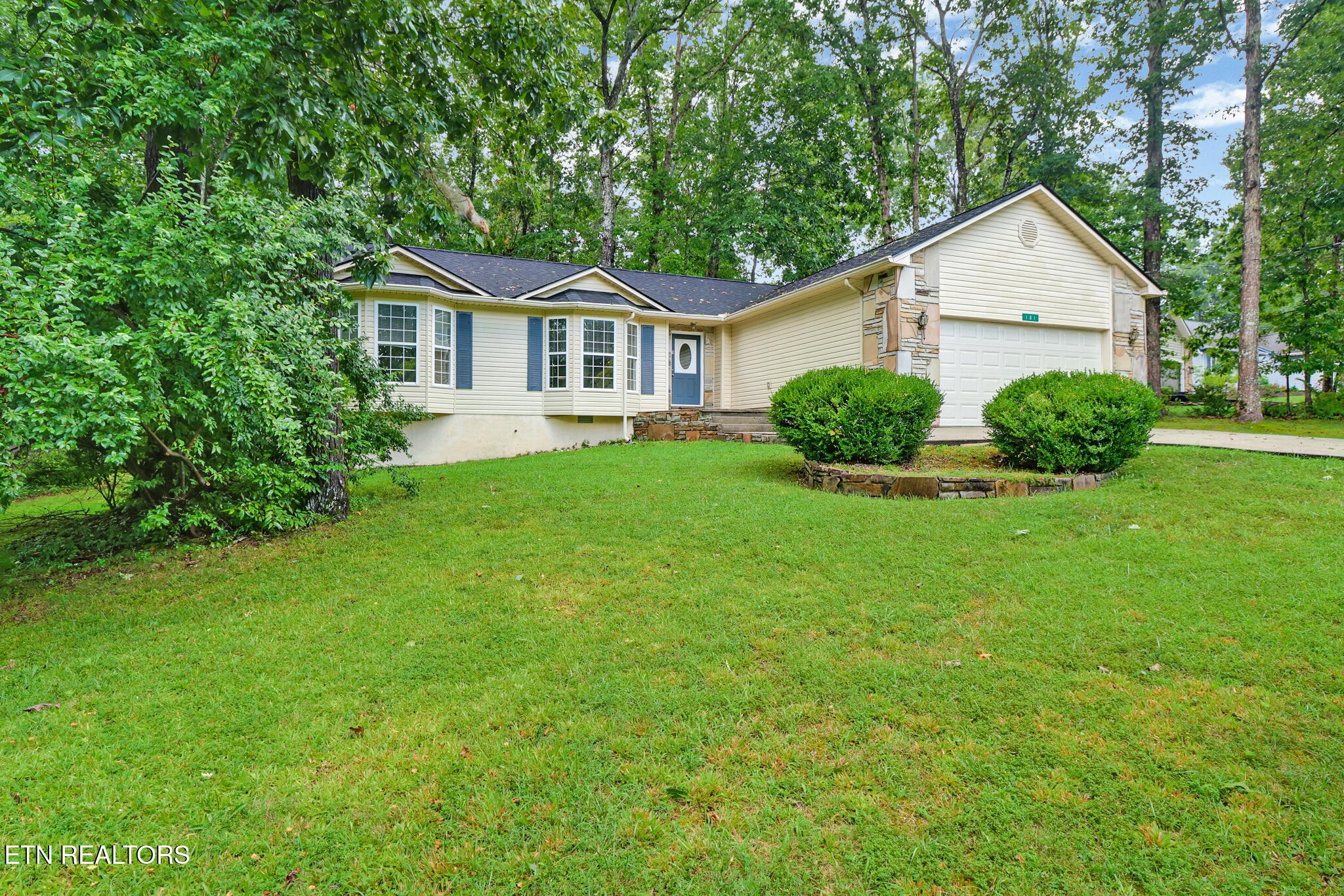 101 Ashdown Lane Crossville, TN 38558 - Photo 3 of 34 a front view of a house with a yard and garage