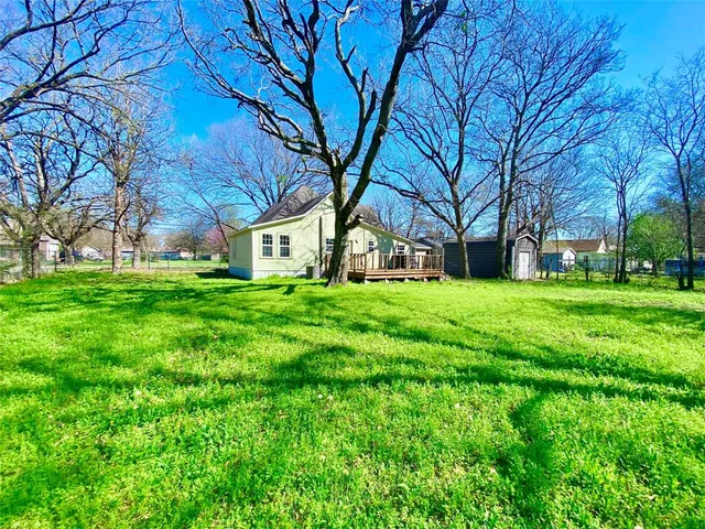 a wooden bench sitting in front of a house