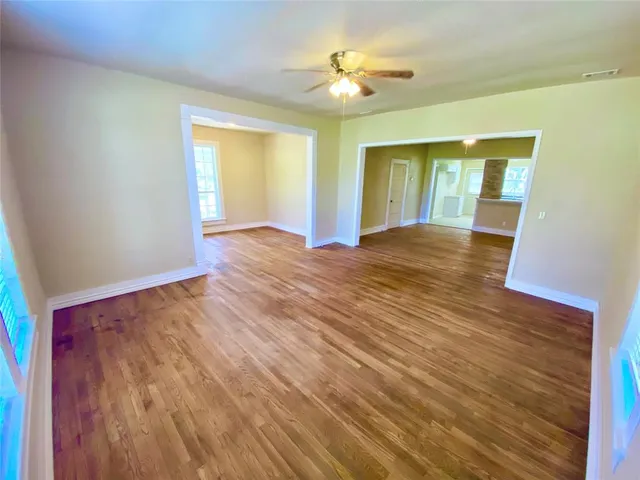 wooden floor in an empty room with a window