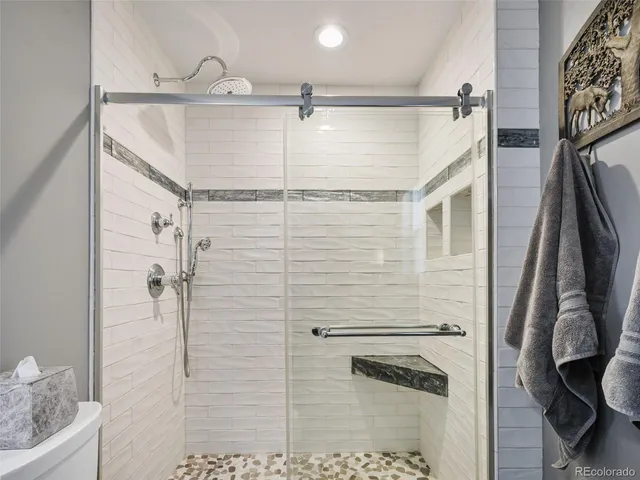 a bathroom with a shower and a glass door