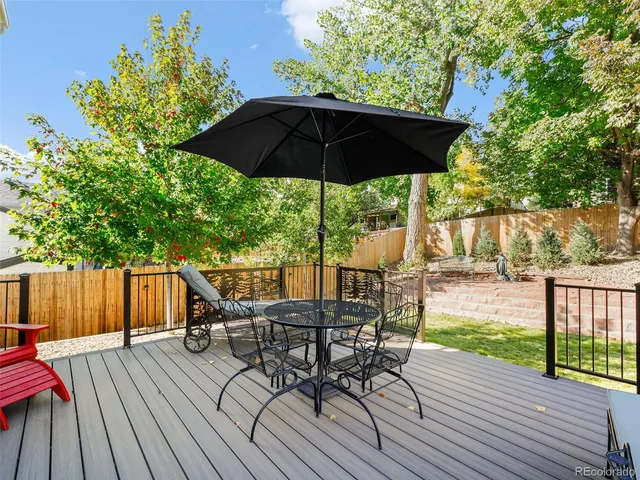 a view of a deck with furniture and yard
