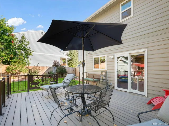 a view of table and chair under an umbrella