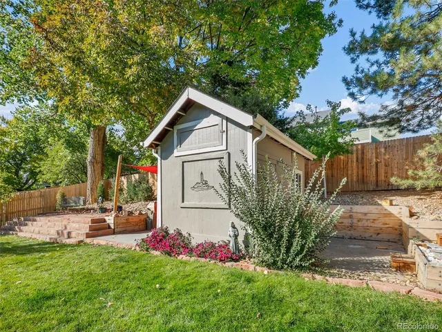 a front view of a house with patio and garden