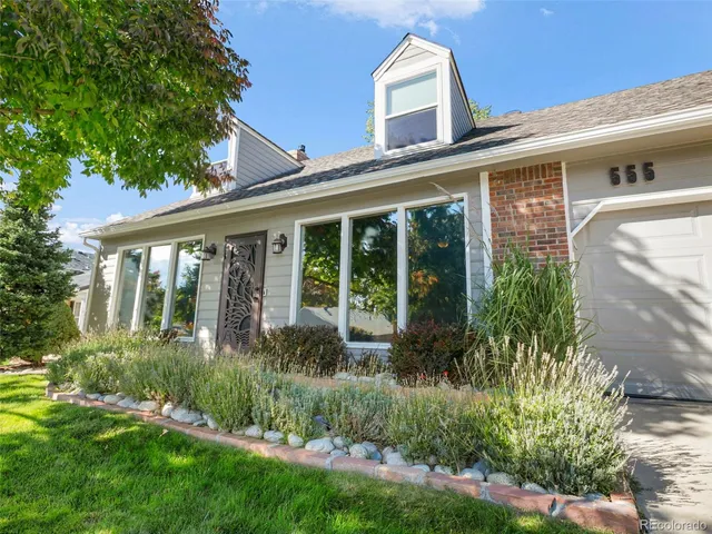 a view of a house with brick walls and a large window