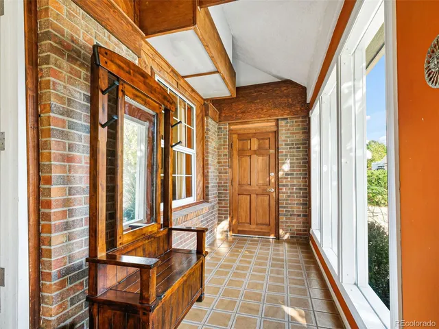 a view of a balcony with furniture and wooden floor