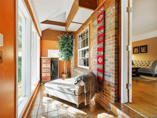 a bedroom with large window and a bed