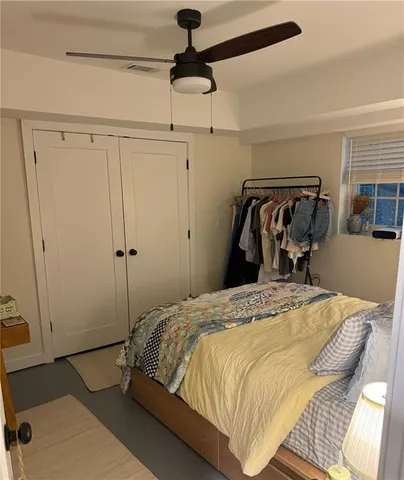 a bedroom with a bed and a mirror