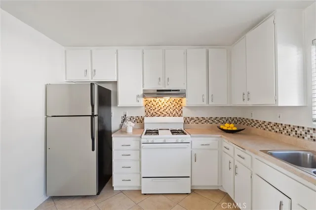 a view of a dining room with furniture and a potted plant