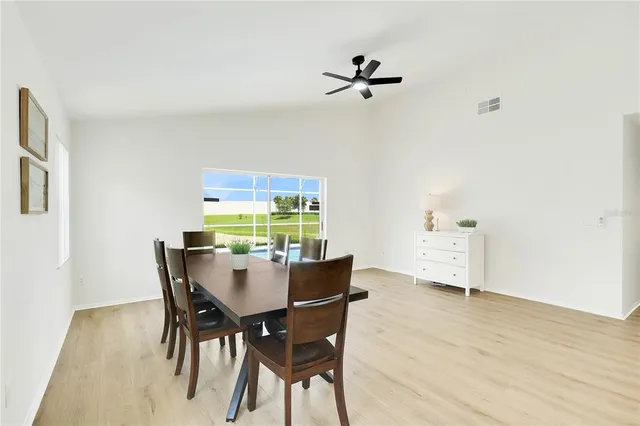 a view of a dining room with furniture and a potted plant
