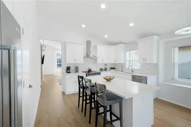 a kitchen with a sink stove top oven and cabinets