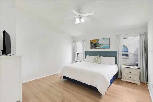 a bedroom with a large bed and a chandelier