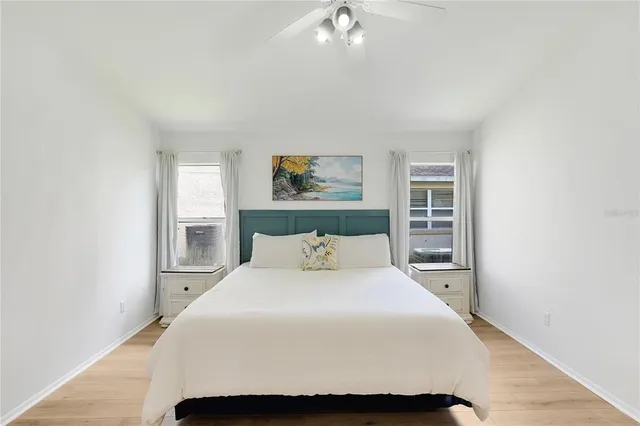 a bedroom with a flat screen tv on the dresser and a flat screen tv