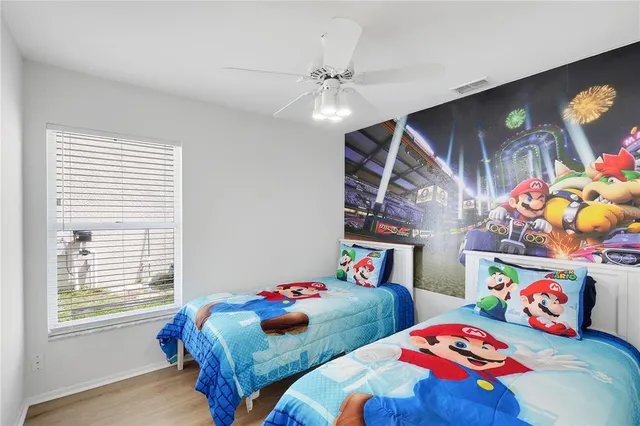 a bedroom with bed and a chandelier