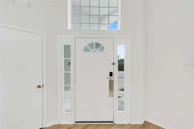 a living room with furniture a flat screen tv and a window
