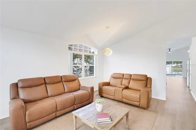 a view of a dining room with furniture and a window