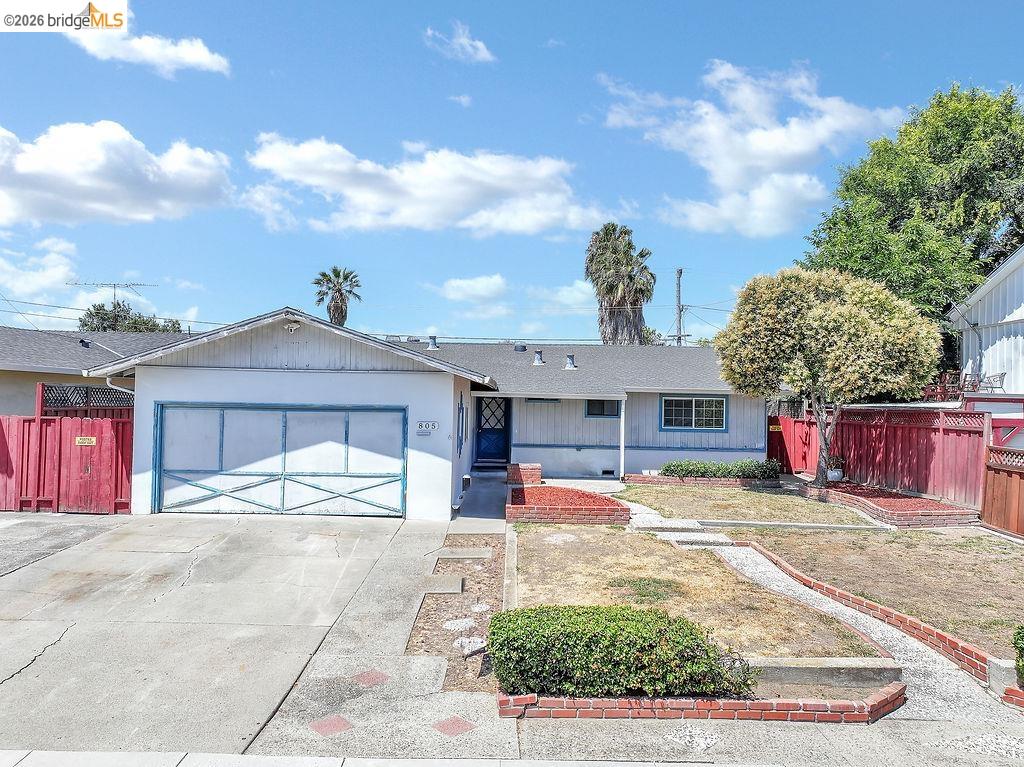 805 Calero Street Milpitas, CA 95035 - Photo 1 of 23 Single-story residence featuring an attached garage with a decorative door, a paved driveway, and a front walkway