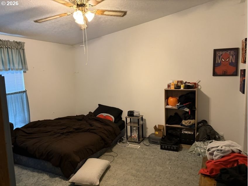 503 Old Pioneer Road Sutherlin, OR 97479 - Photo 12 of 48 a bedroom with a bed and a chandelier