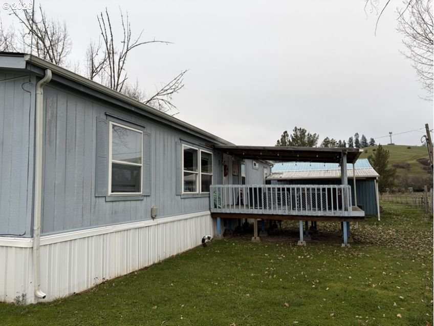 503 Old Pioneer Road Sutherlin, OR 97479 - Photo 18 of 48 a view of a house with wooden deck and a yard