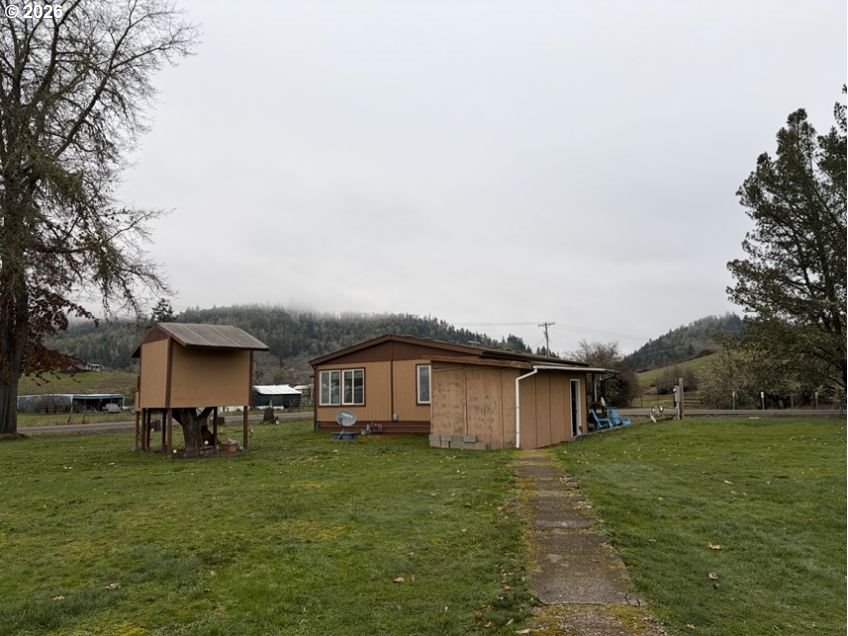 503 Old Pioneer Road Sutherlin, OR 97479 - Photo 30 of 48 a view of a house with a yard
