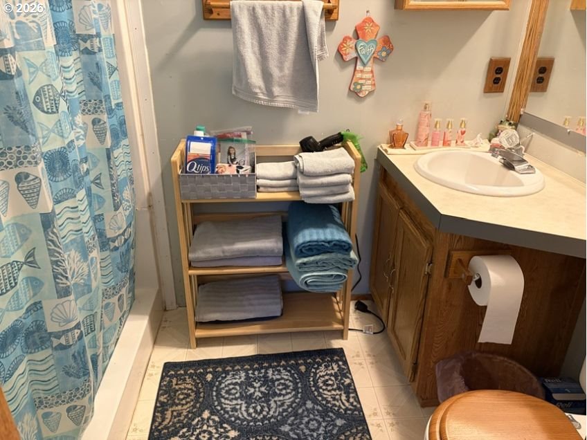 503 Old Pioneer Road Sutherlin, OR 97479 - Photo 46 of 48 a bathroom with a sink and a mirror