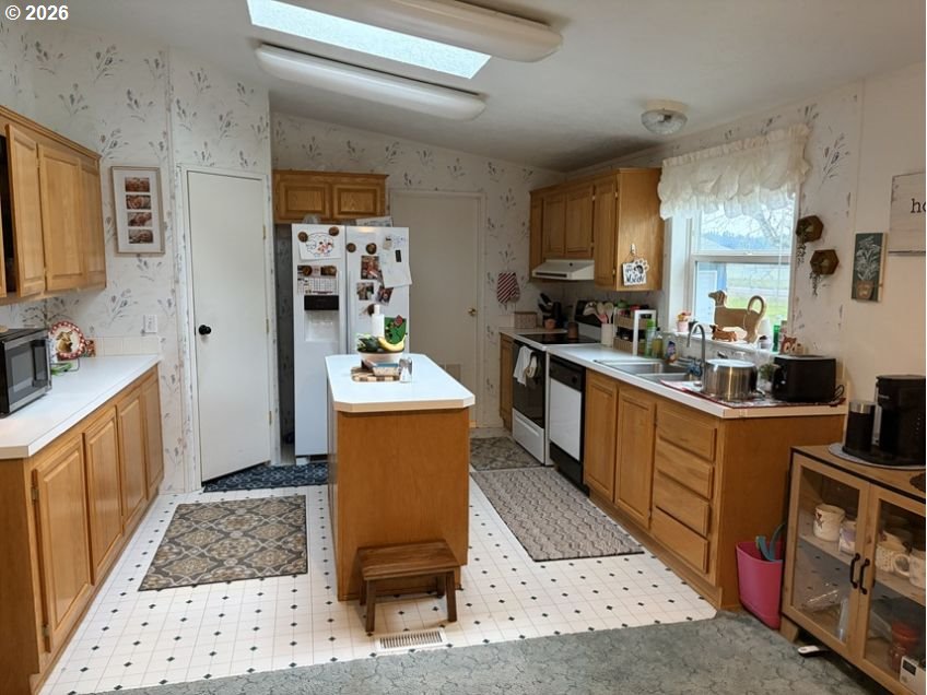 503 Old Pioneer Road Sutherlin, OR 97479 - Photo 6 of 48 a kitchen with sink a refrigerator and cabinets