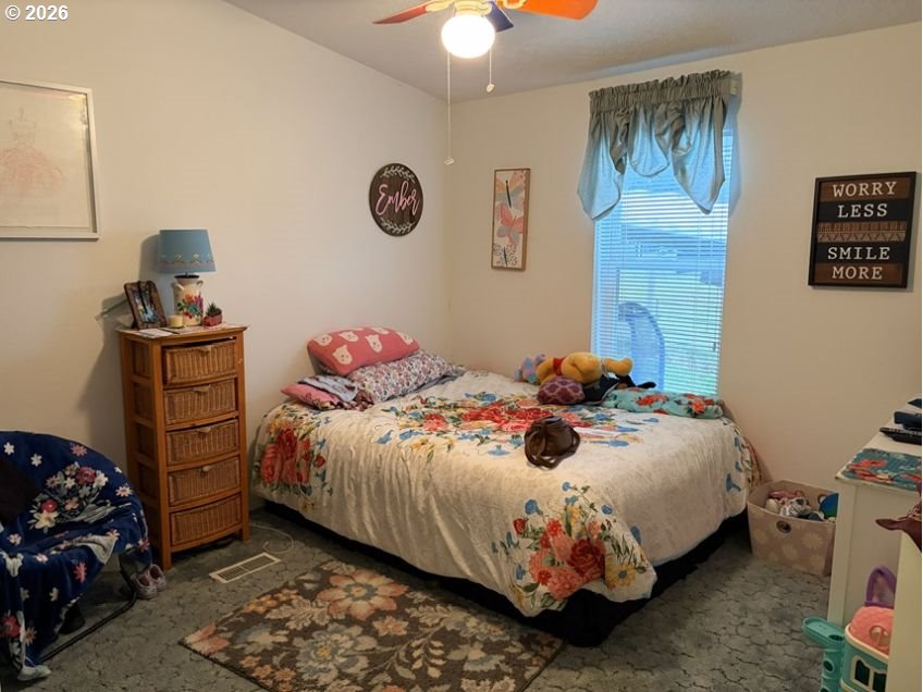 503 Old Pioneer Road Sutherlin, OR 97479 - Photo 10 of 48 a bedroom with a bed and a chandelier