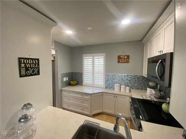 a kitchen with a sink cabinets and window