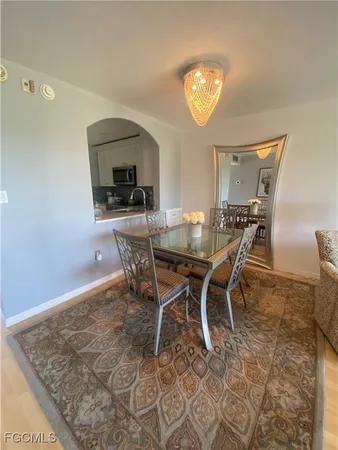 a dining room with a wooden table and chairs