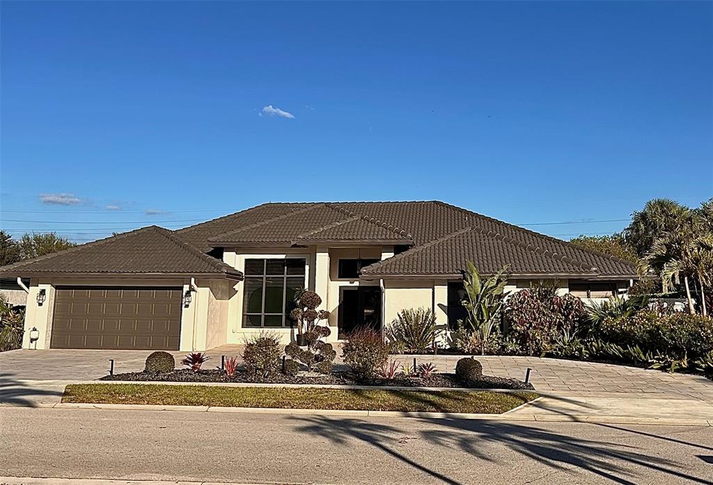 a front view of a house with a garden