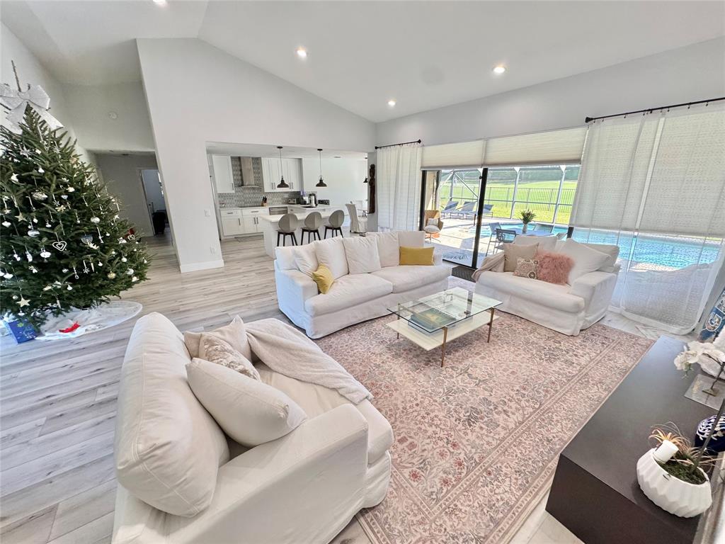 11392 Boca Woods Lane Boca Raton, FL 33428 - Photo 2 of 26 a living room with furniture and a large window