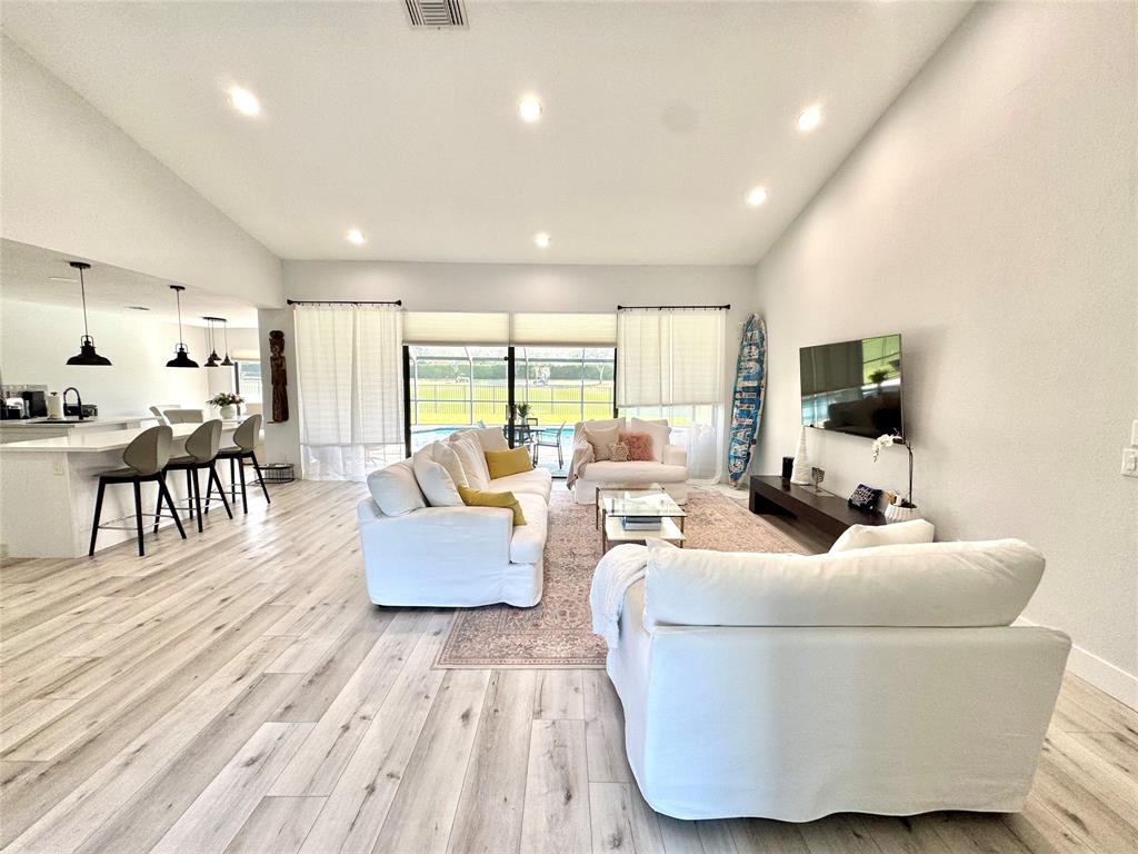11392 Boca Woods Lane Boca Raton, FL 33428 - Photo 4 of 26 a living room with furniture and a flat screen tv