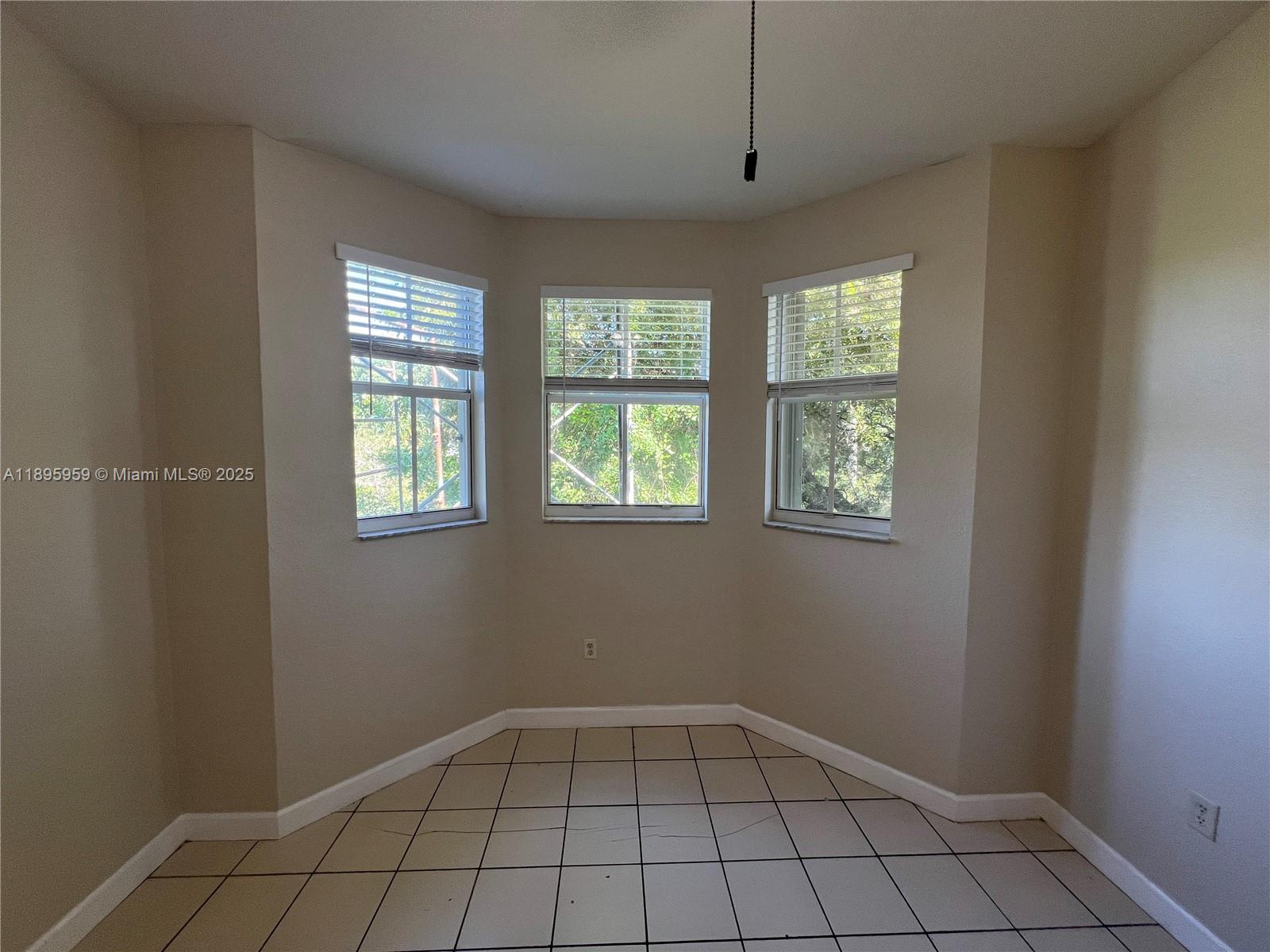 2903 Southeast 17th Avenue, Unit 201 Homestead, FL 33035 - Photo 11 of 42 an empty room with windows