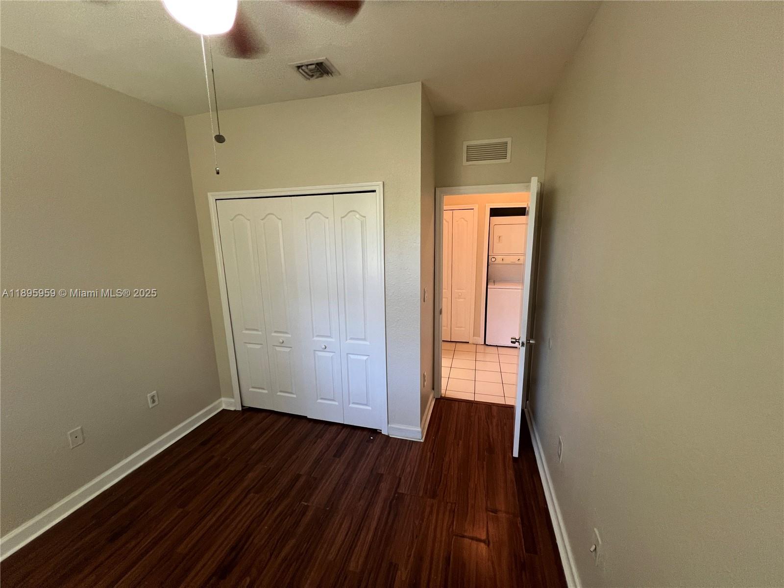 2903 Southeast 17th Avenue, Unit 201 Homestead, FL 33035 - Photo 17 of 42 a view of an empty room with wooden floor and a window
