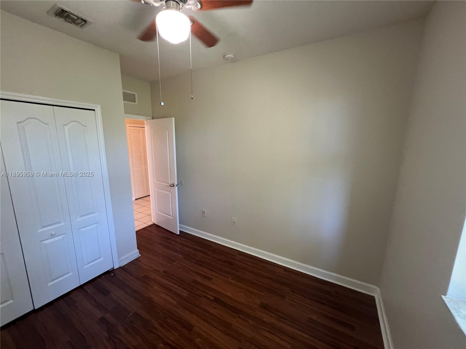 2903 Southeast 17th Avenue, Unit 201 Homestead, FL 33035 - Photo 20 of 42 a view of an empty room with wooden floor