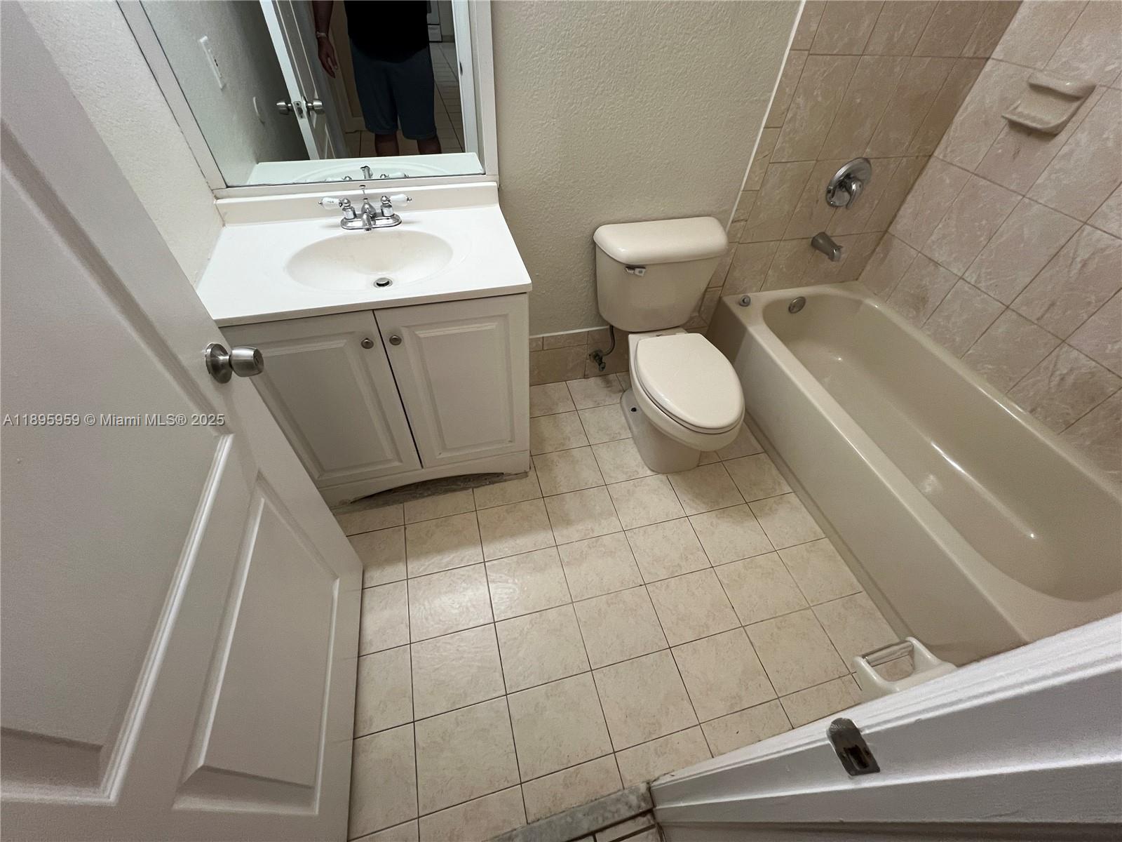 2903 Southeast 17th Avenue, Unit 201 Homestead, FL 33035 - Photo 22 of 42 a bathroom with a sink a toilet and shower
