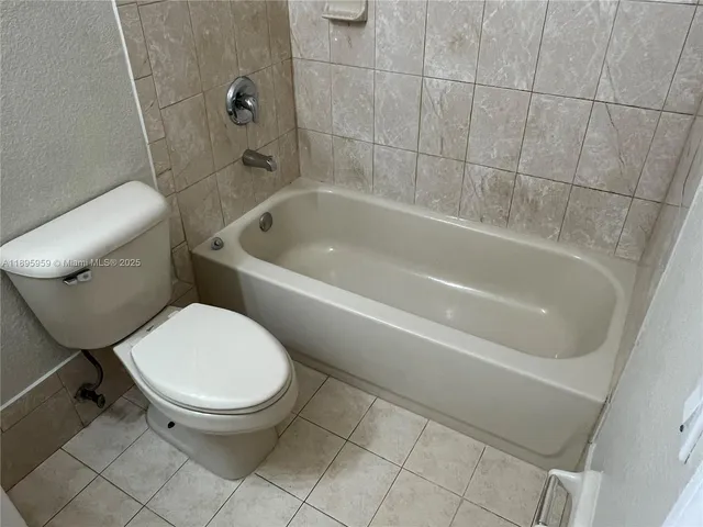 a bathroom with a shower and toilet