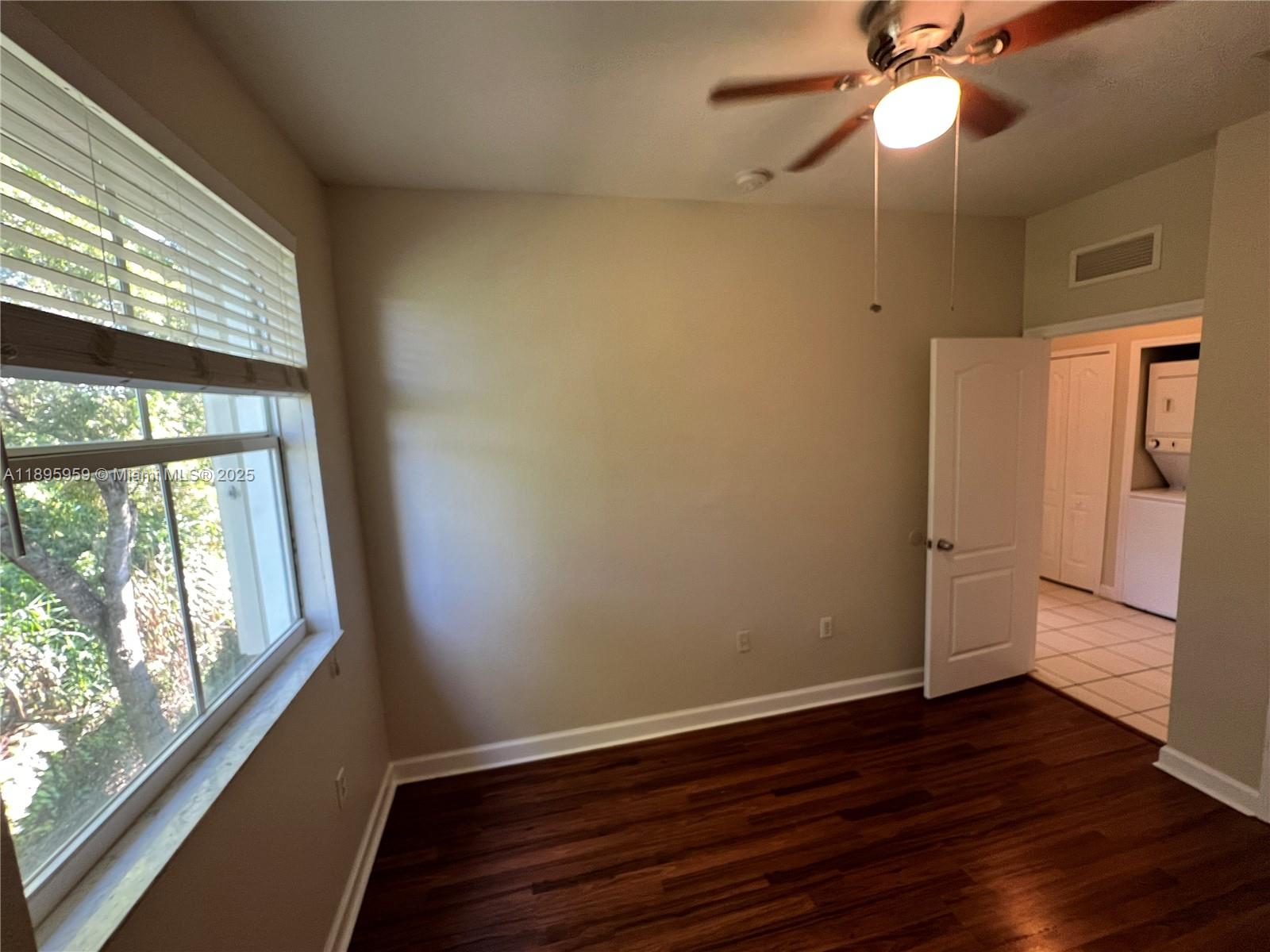 2903 Southeast 17th Avenue, Unit 201 Homestead, FL 33035 - Photo 30 of 42 a view of empty room with wooden floor and fan