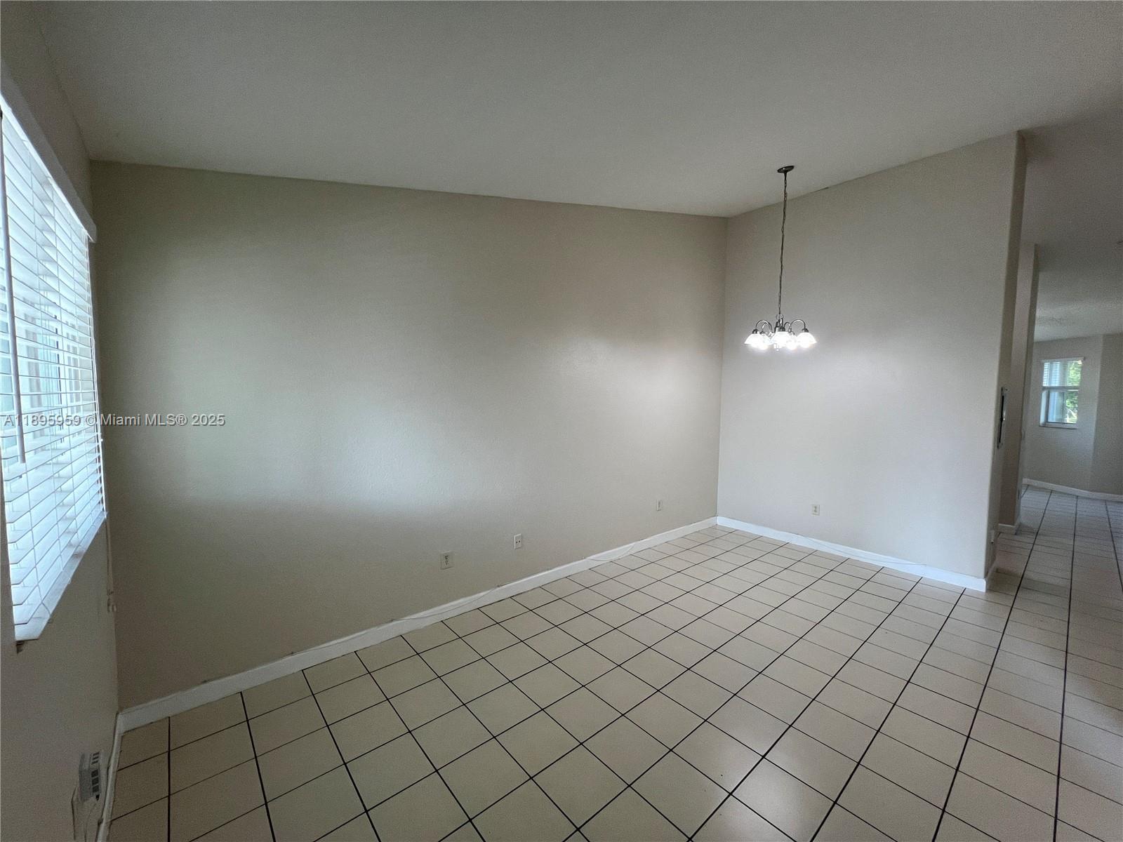 2903 Southeast 17th Avenue, Unit 201 Homestead, FL 33035 - Photo 3 of 42 an empty room with windows